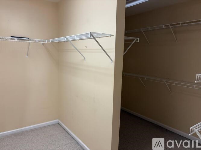 A white clothes drying rack is on the wall.