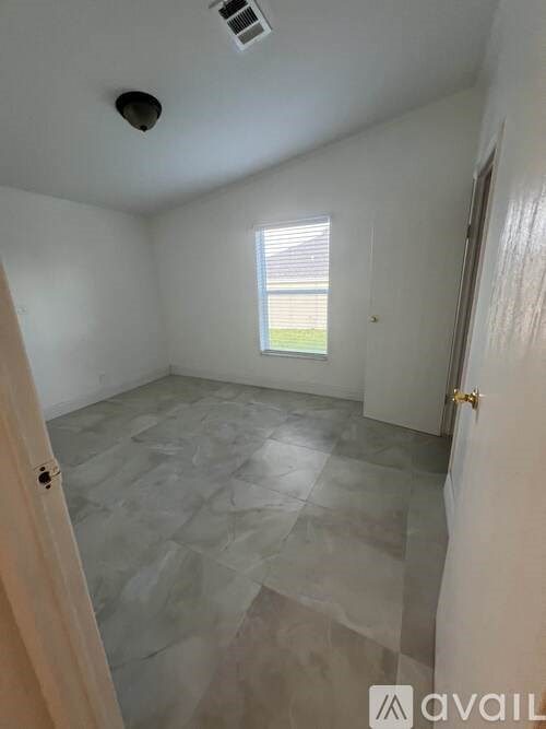 A room with a slanted ceiling and a window.