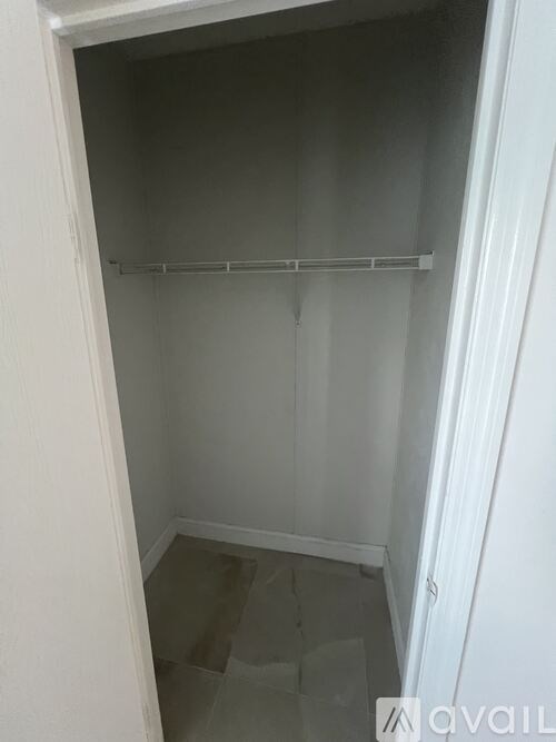 A white closet with a shelf and no clothes.