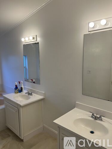 A bathroom with a sink and mirror.