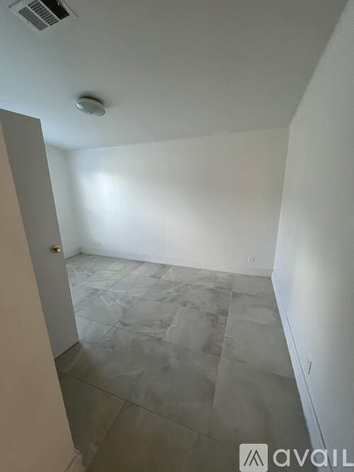 A room with a tiled floor and a ceiling fan.