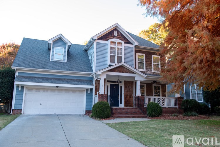 A house with a blue garage door and a white front door.