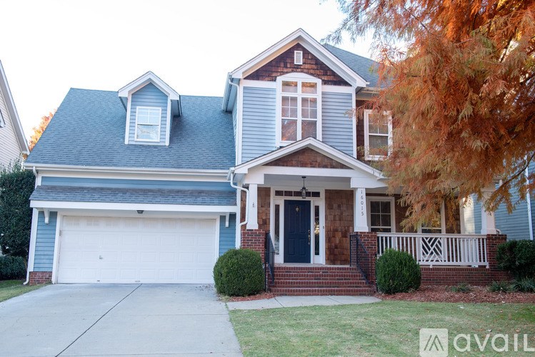 A house with a blue garage door and a white front door.