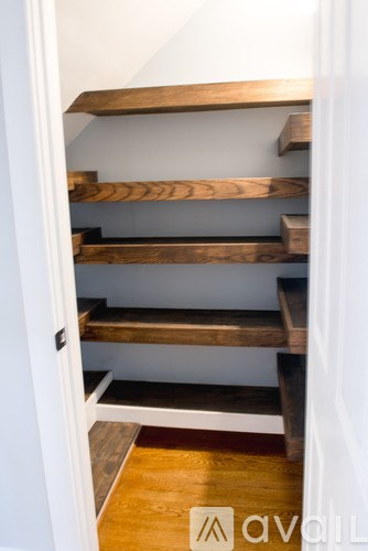 A set of stairs with wooden steps and handrails.