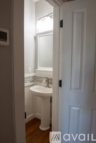 A white bathroom sink with a mirror above it.