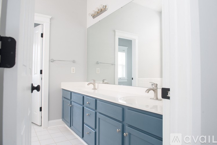 A bathroom with a white sink and a mirror above it.