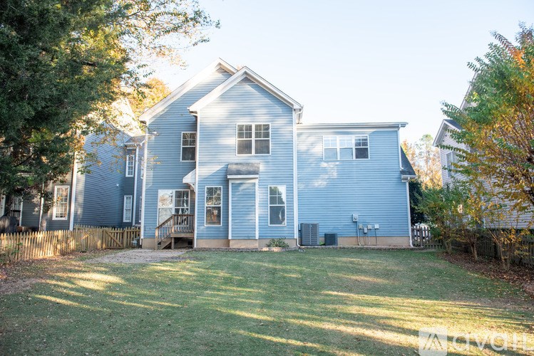 A blue house with a white door and windows.