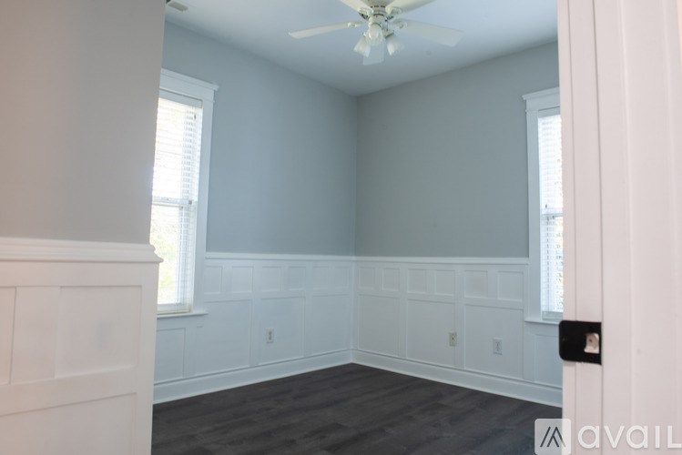 A room with a ceiling fan and a window.