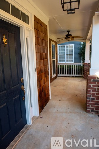 A dark blue door with a brass handle is on the left and a white door on the right.