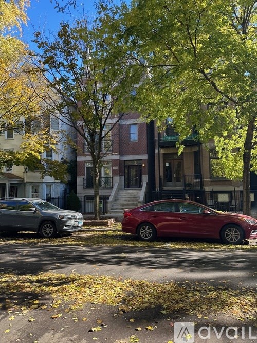 A red car is parked on the side of a street.