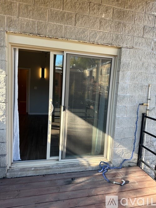 A window with a glass door and a blue cord on the floor.