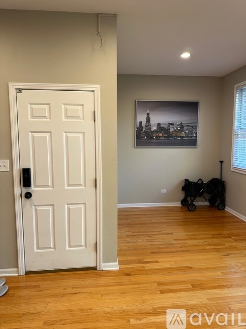 A white door with a black handle is on the left side of the image.