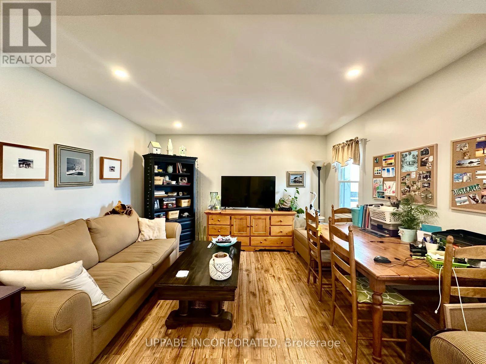 A living room with a couch, a coffee table, and a television.