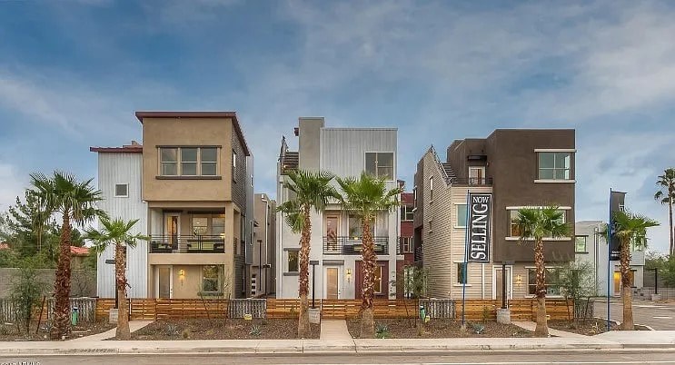 A modern residential building with the name "ENNITIS" on the front.