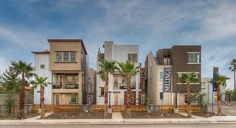 A modern residential building with the name "ENNITIS" on the front.