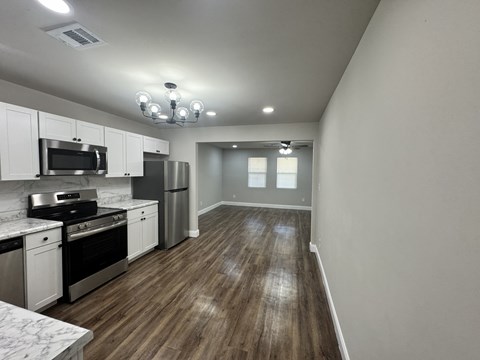 A kitchen with white cabinets and stainless steel appliances.