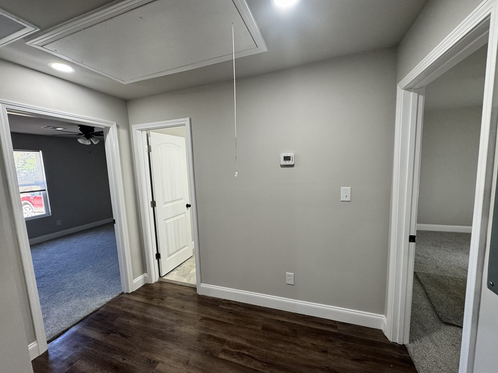 A room with a white door and a window.