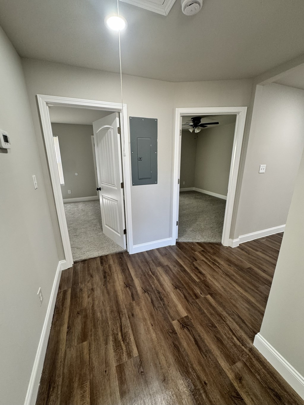 A room with a wooden floor and a ceiling fan.