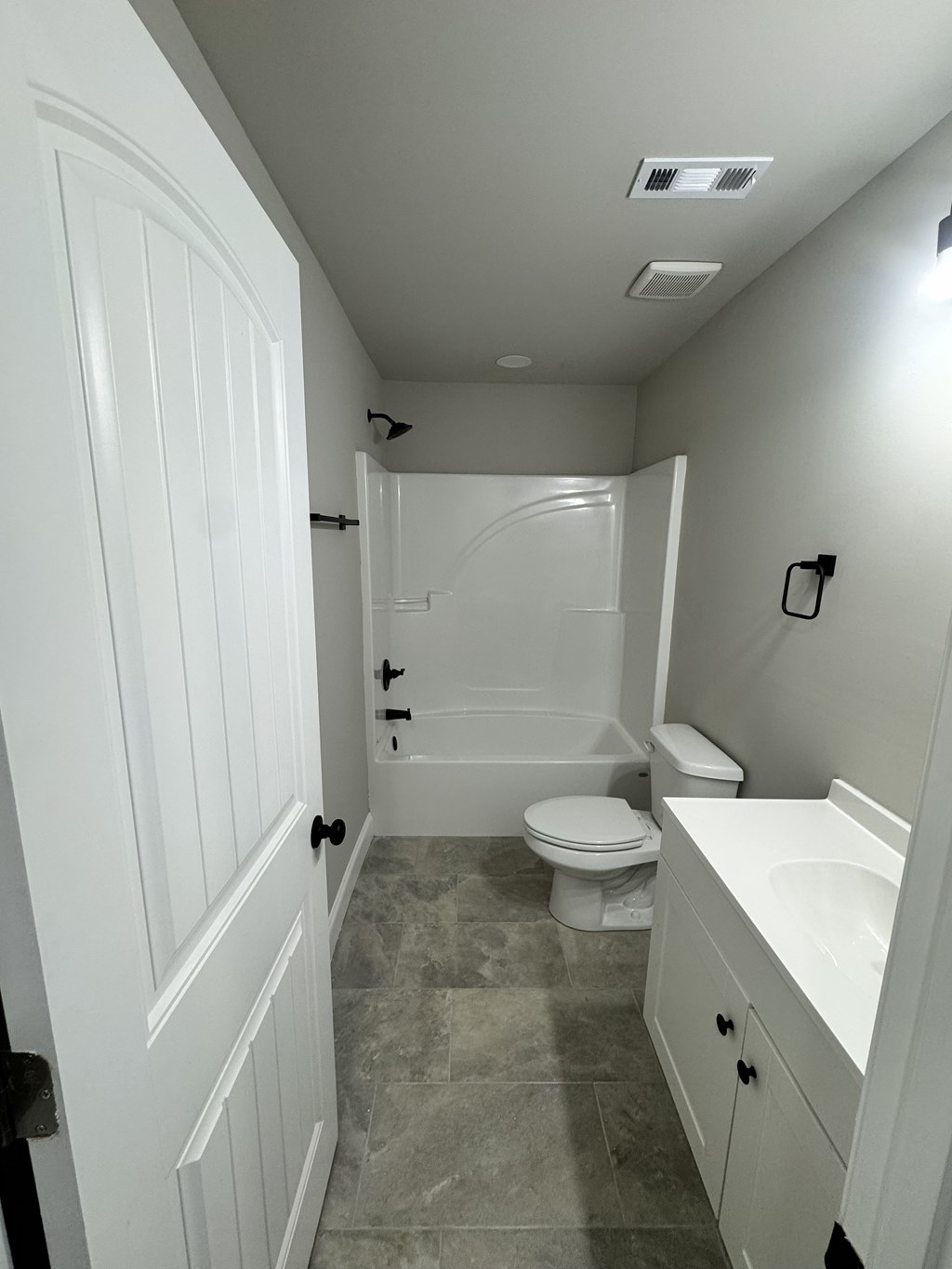 A bathroom with a toilet, sink, and bathtub.