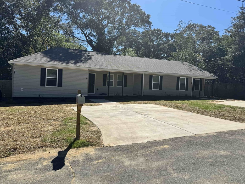 A house with a grey roof and a white garage door.