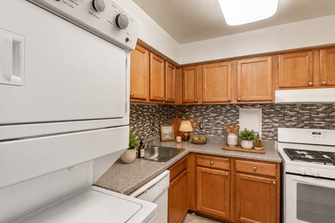 A white oven in a kitchen with wooden cabinets.