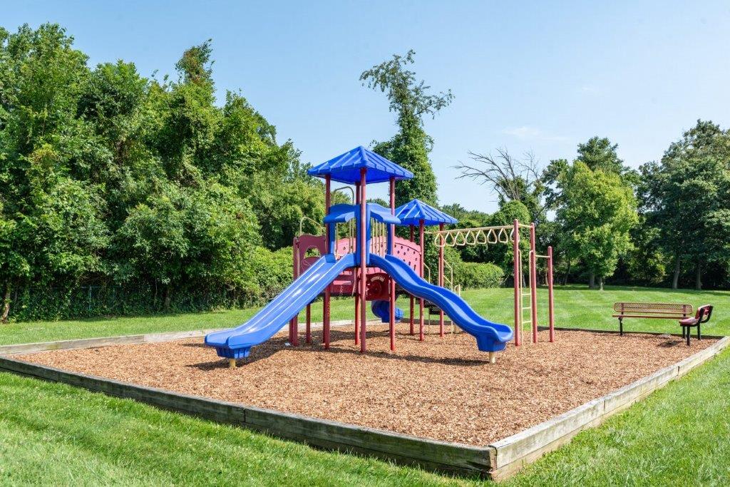 Mulch playground with 2 benches nearby