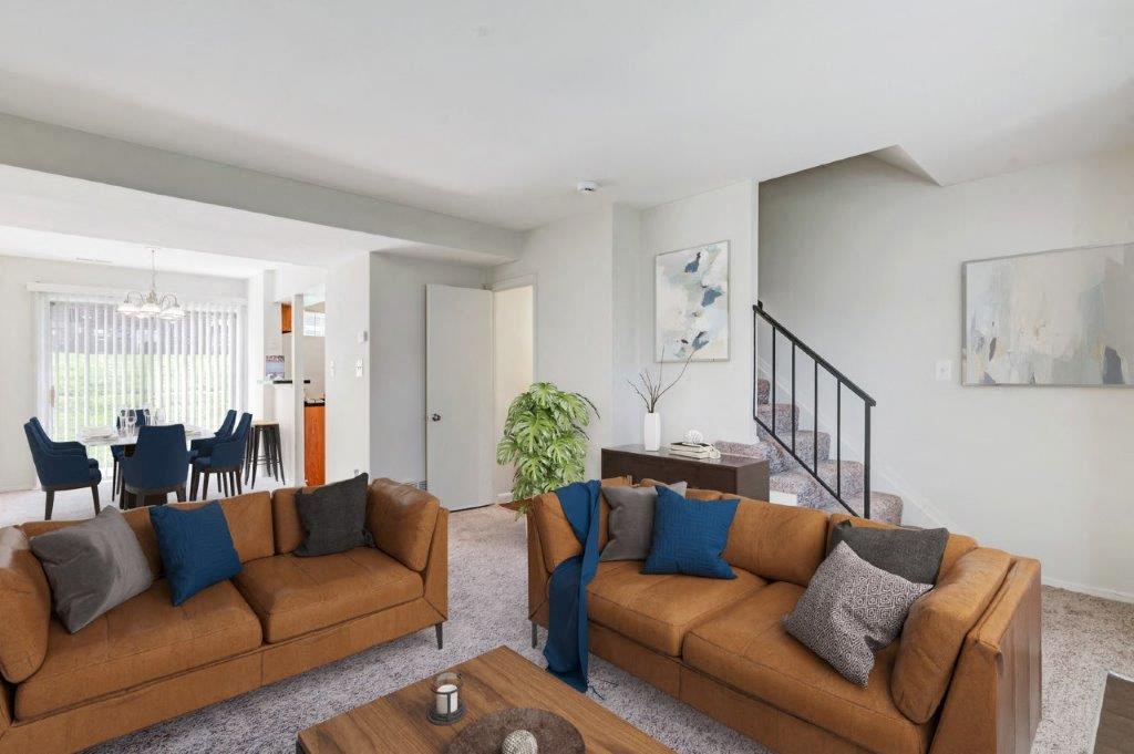 Staged living room in townhome with carpet throughout