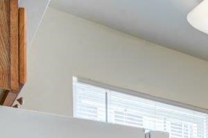 Kitchen with maple cabinets, white appliances, tile backsplash