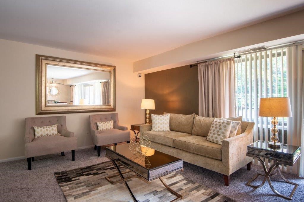 a living room with a couch and a glass table