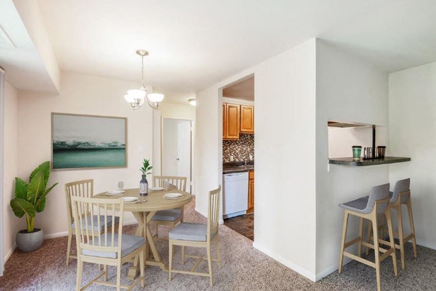 a dining room with a table and chairs and a kitchen