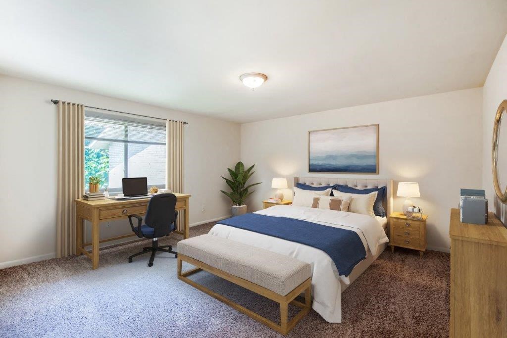 a bedroom with a bed and a desk and a window