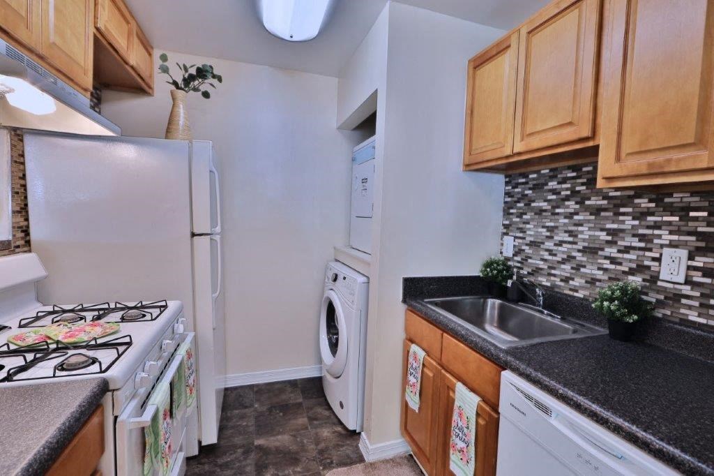 a kitchen with a stove refrigerator and a washing machine
