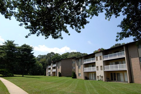 Apartment building with a green lawn in front.