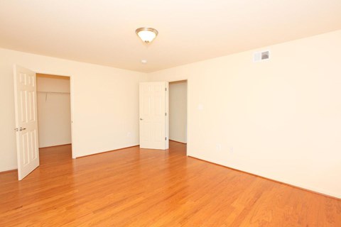 A room with wooden floors and white walls.