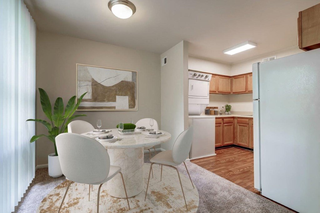 a dining room with a table and chairs and a kitchen