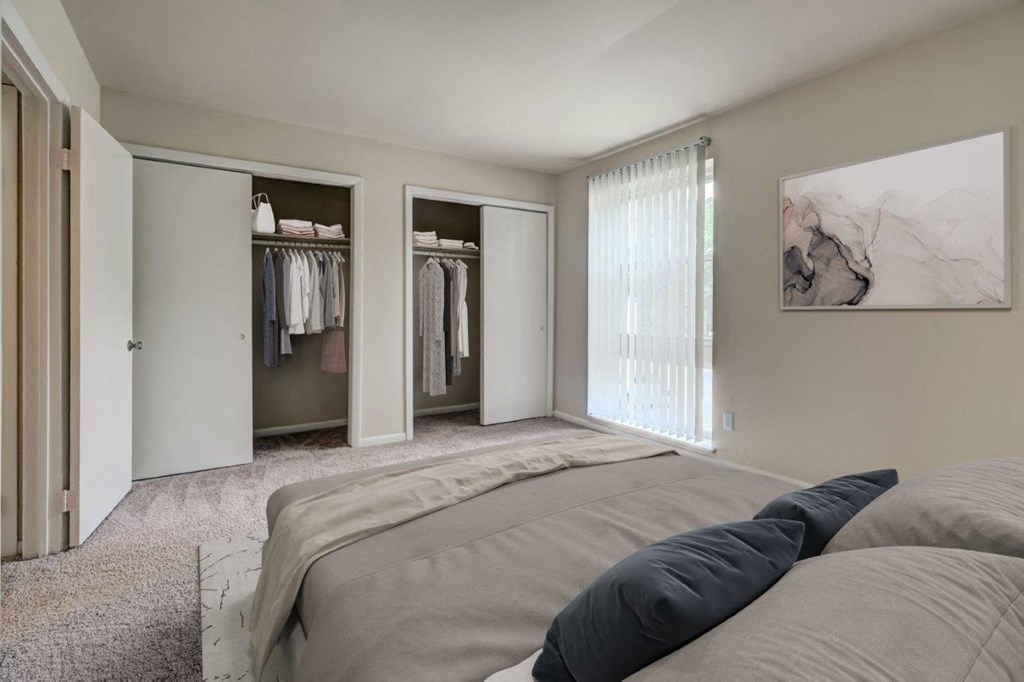 a master bedroom with a closet and a bed