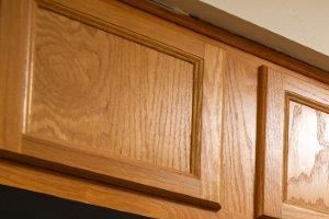 a kitchen with black appliances and wooden cabinets