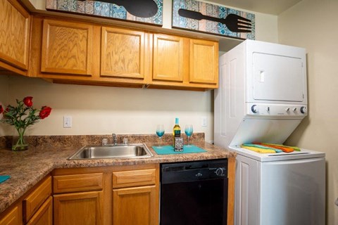 a small kitchen with a sink and a refrigerator