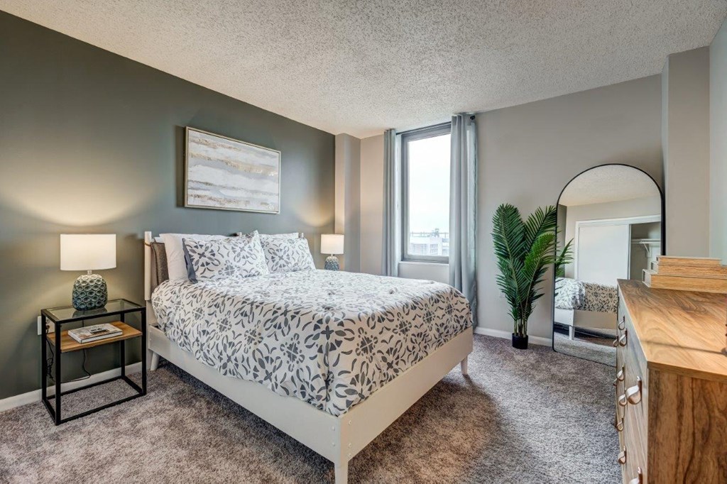 a bedroom with a bed and a window