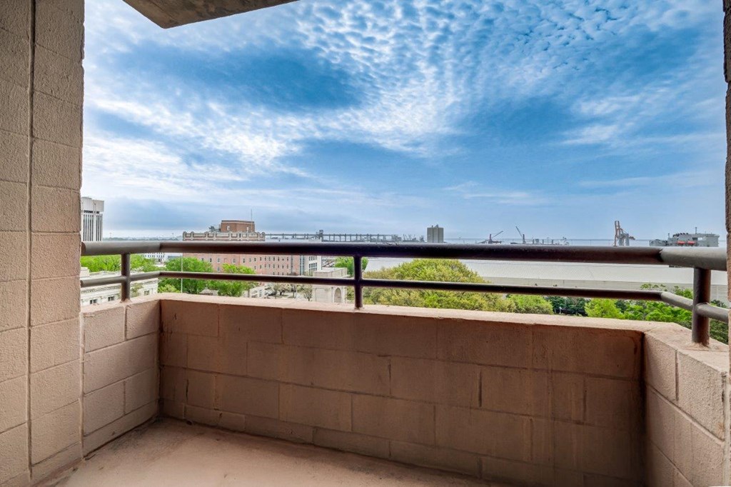 the balcony has a view of the water and the city