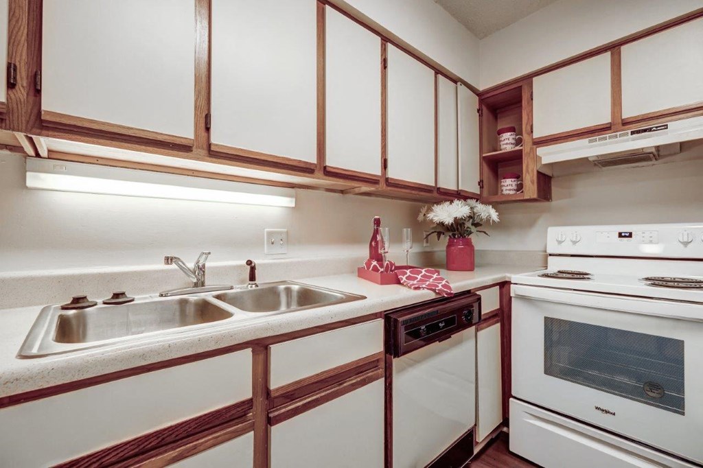 a kitchen with white appliances and wooden cabinets