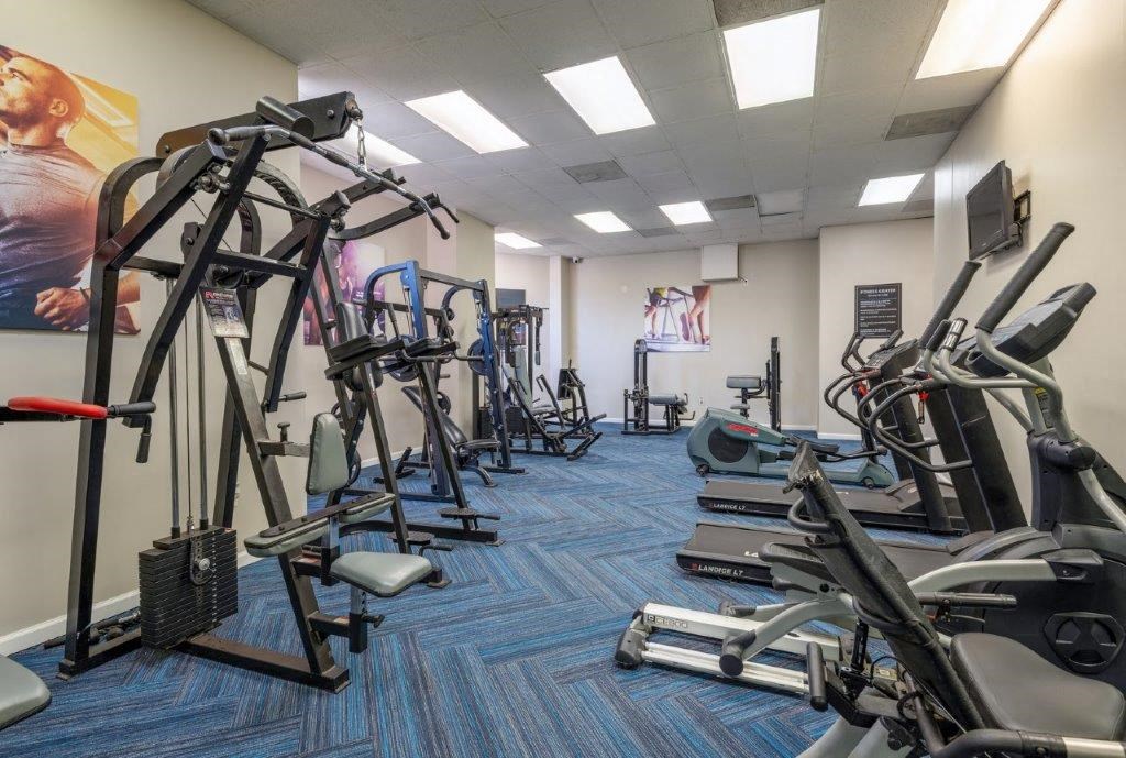 a gym with various exercise equipment in a room