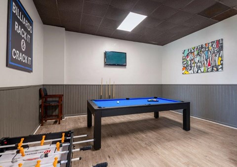 a game room with a blue pool table