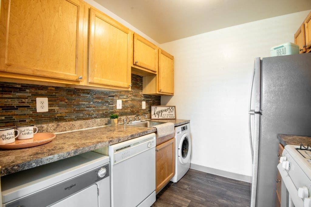 a kitchen with a washer and dryer and a sink