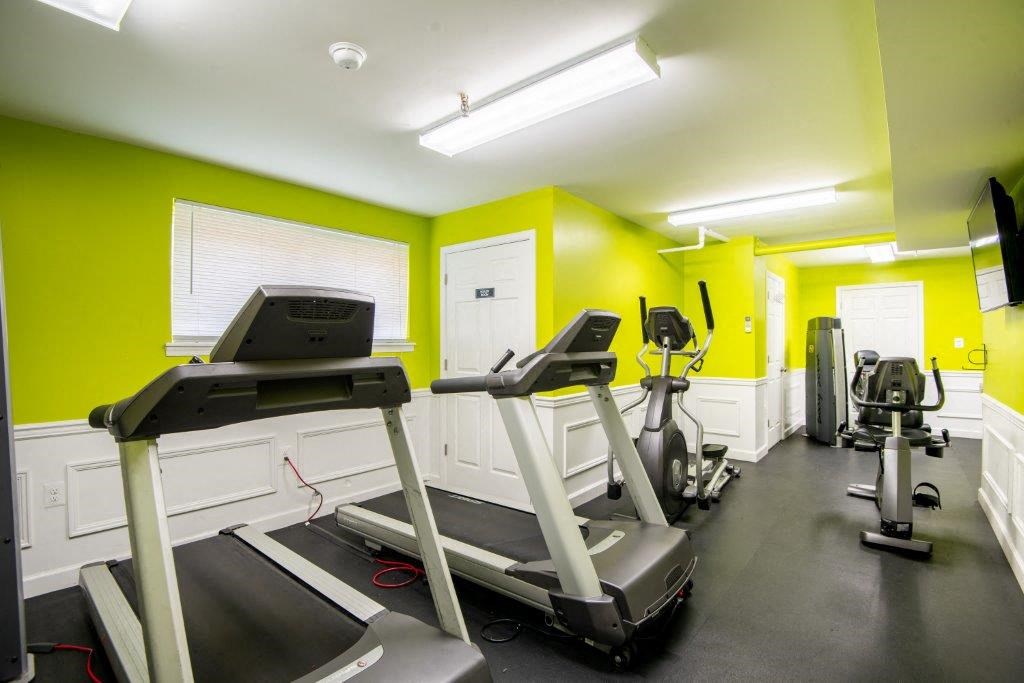 a gym with treadmills and other exercise equipment