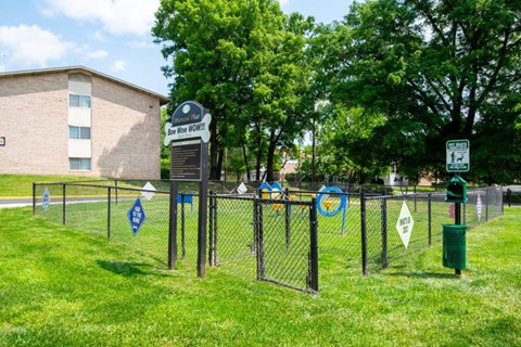 a chain link fence with blue and white signs on it