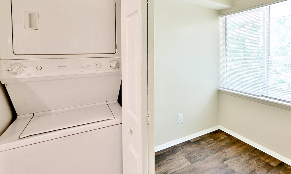 an empty laundry room with a washer and dryer