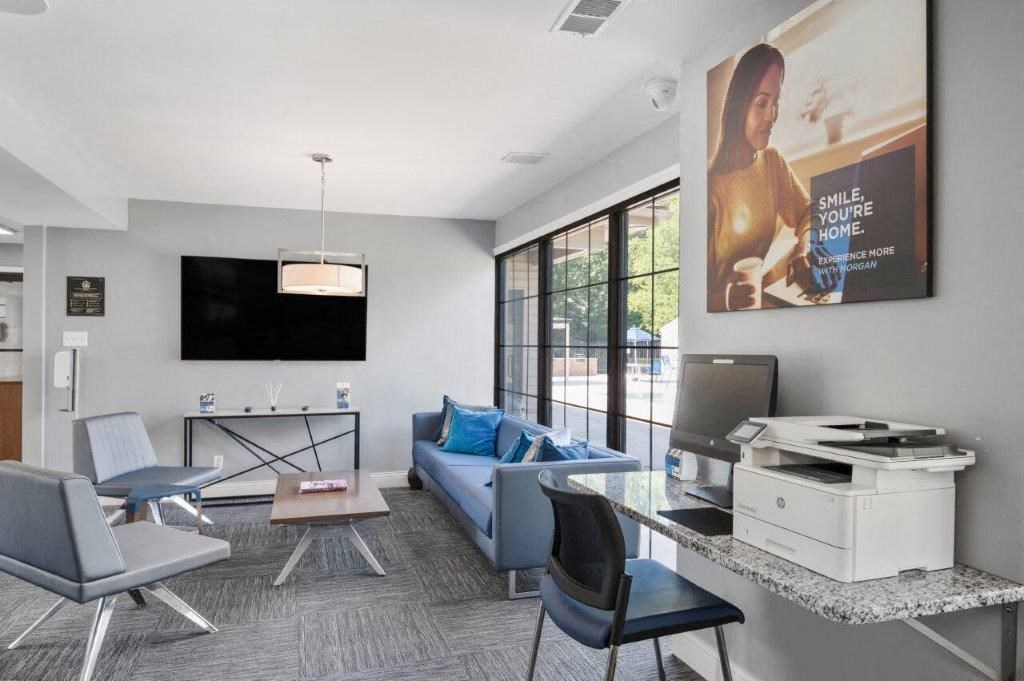 a living room with a couch and a desk and a television