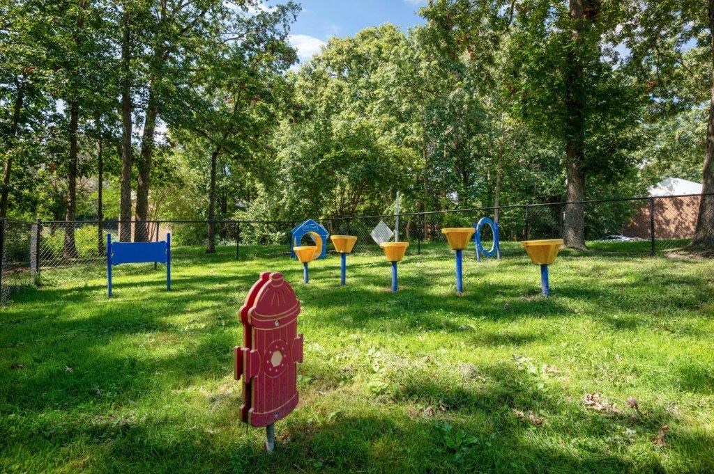 a red fire hydrant in the middle of a field