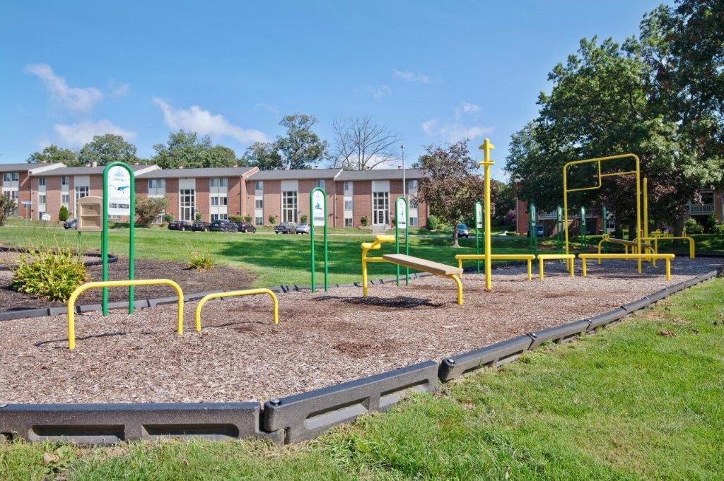 a playground in a park in front of a building